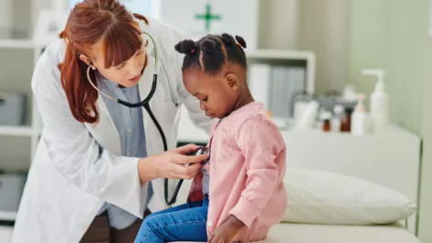 Doctor with stethoscope and pediatrics patient