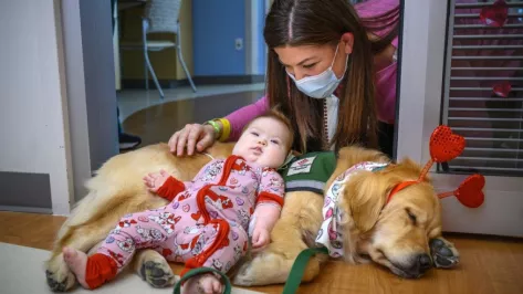 Child Life Specialist and pet therapy dog during Texas Children’s during a special dog parade today