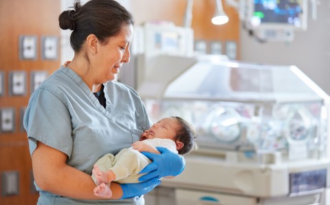 Nurse in NICU with baby